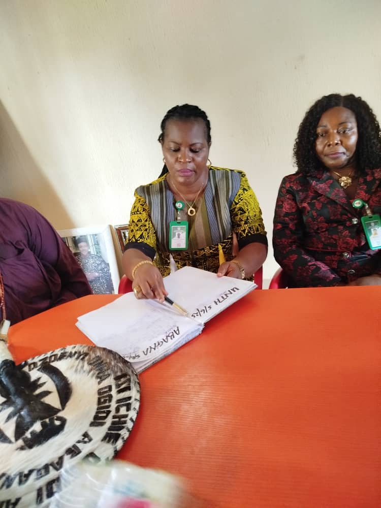 The DA, Mrs Obi, signs the attendance register